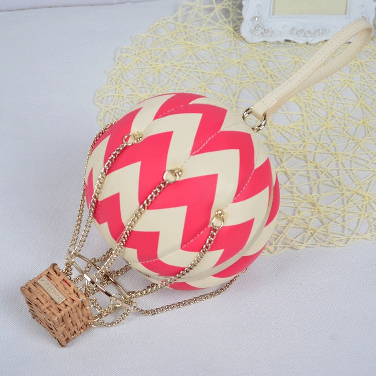 Bolsa clutch com balão de ar quente